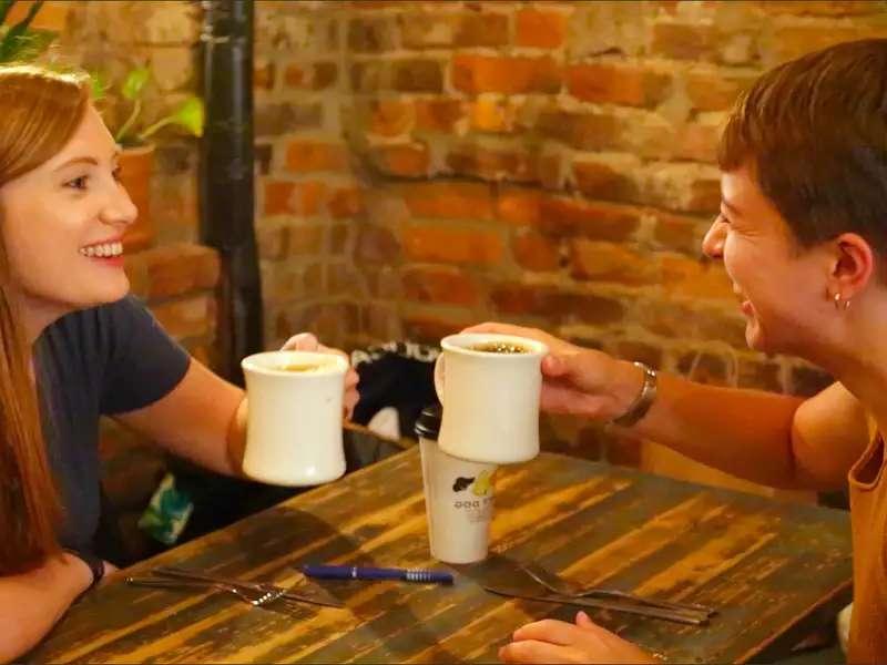 2 young women with coffee mugs